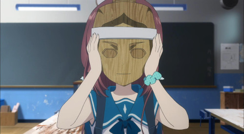 Image of Manaka with the wooden mask on her face