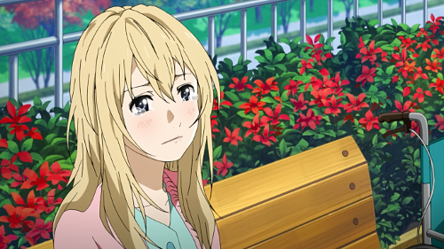 Kaori looking up from her seat at Kousei with tears in her eyes